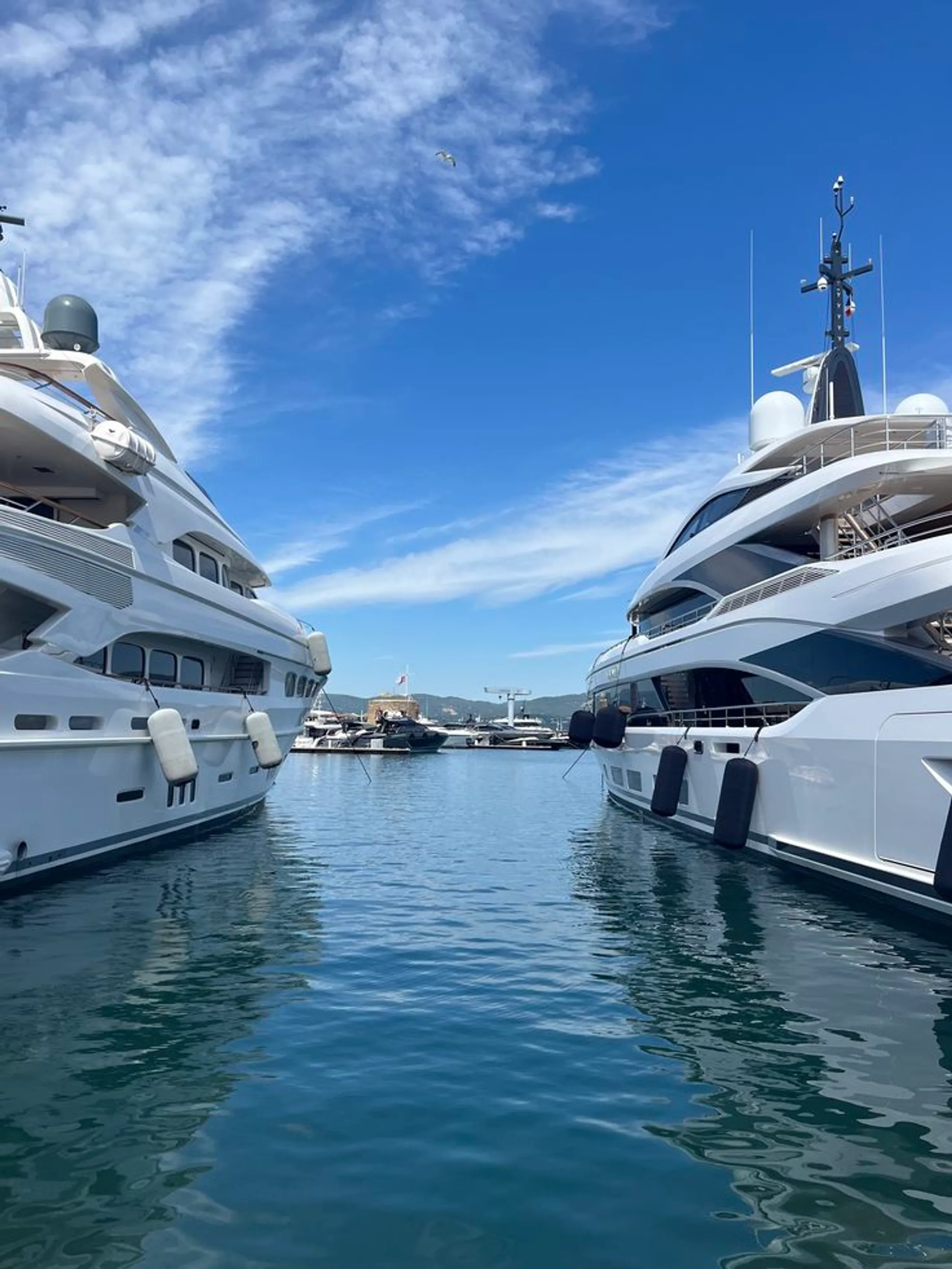 Superyachts berthed in a marina under professional yacht management