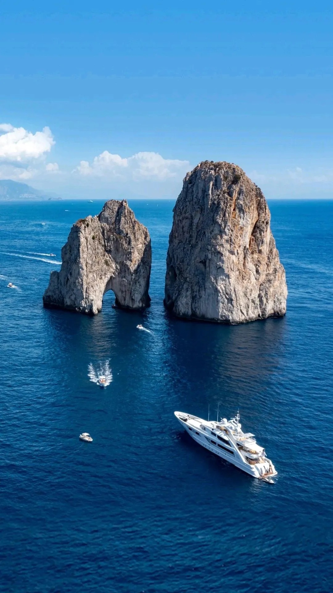 Yacht cruising near the Faraglioni rocks in Capri