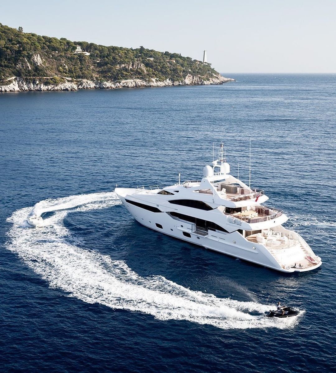 Superyacht cruising off the Mediterranean coast with water toys in use