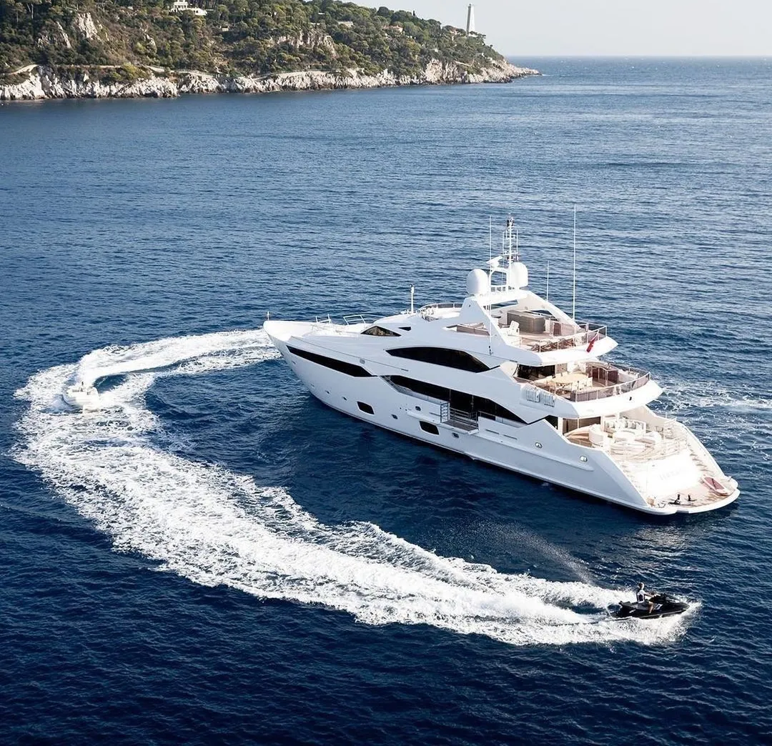 Superyacht cruising off the Mediterranean coast with water toys in use