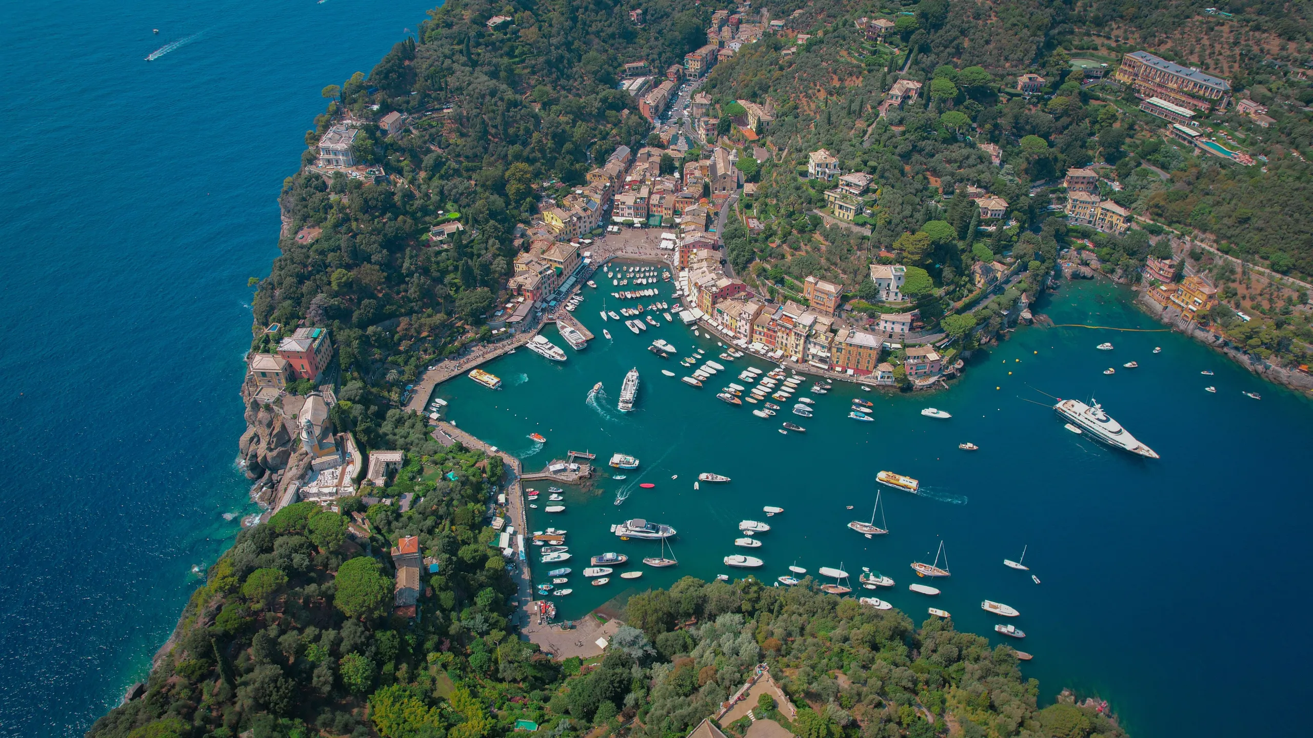 Yachts anchored off the French Riviera coastline under a clear blue sky