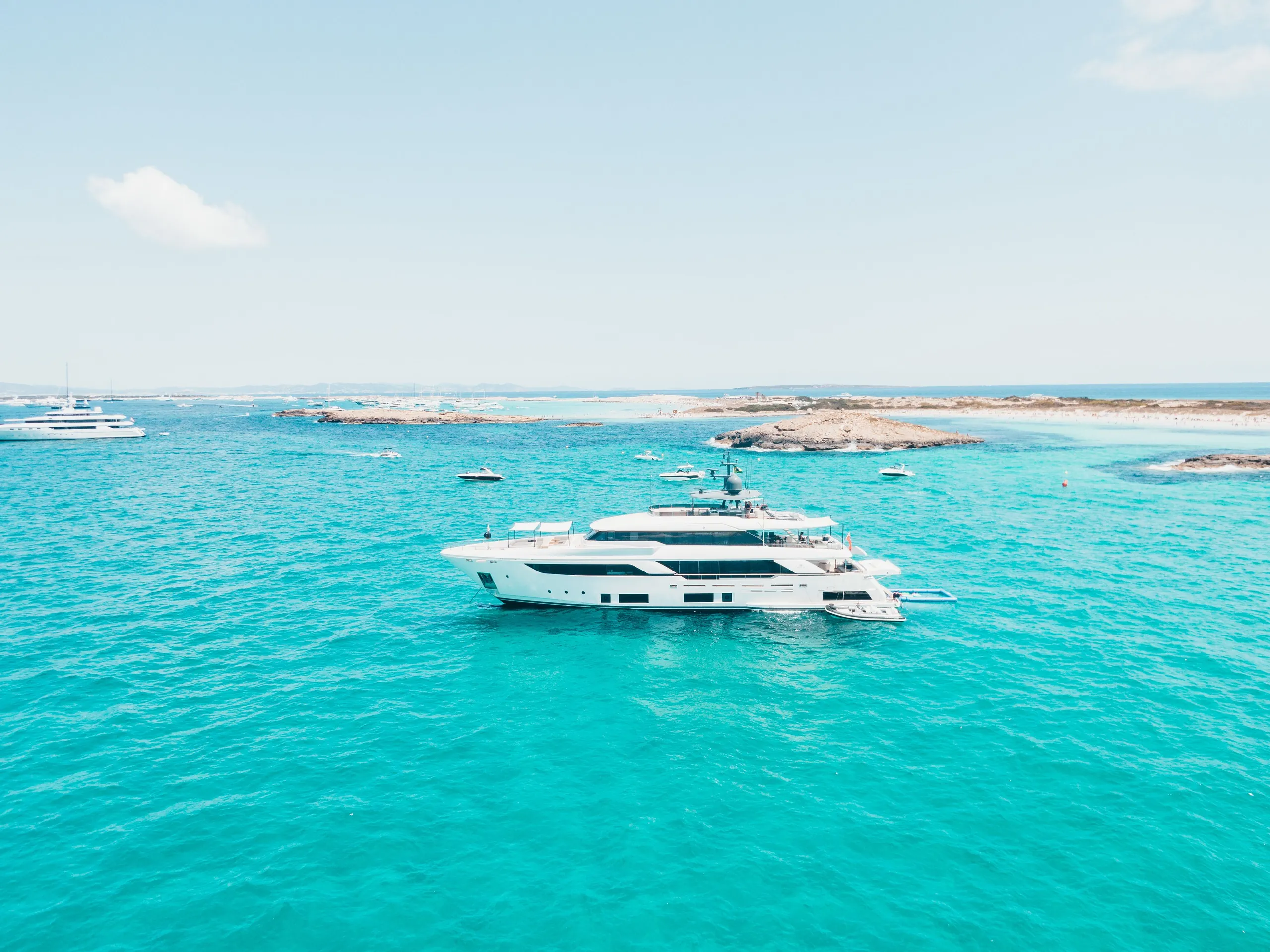Luxury yacht anchored in turquoise waters in Ibiza and the Balearic Islands
