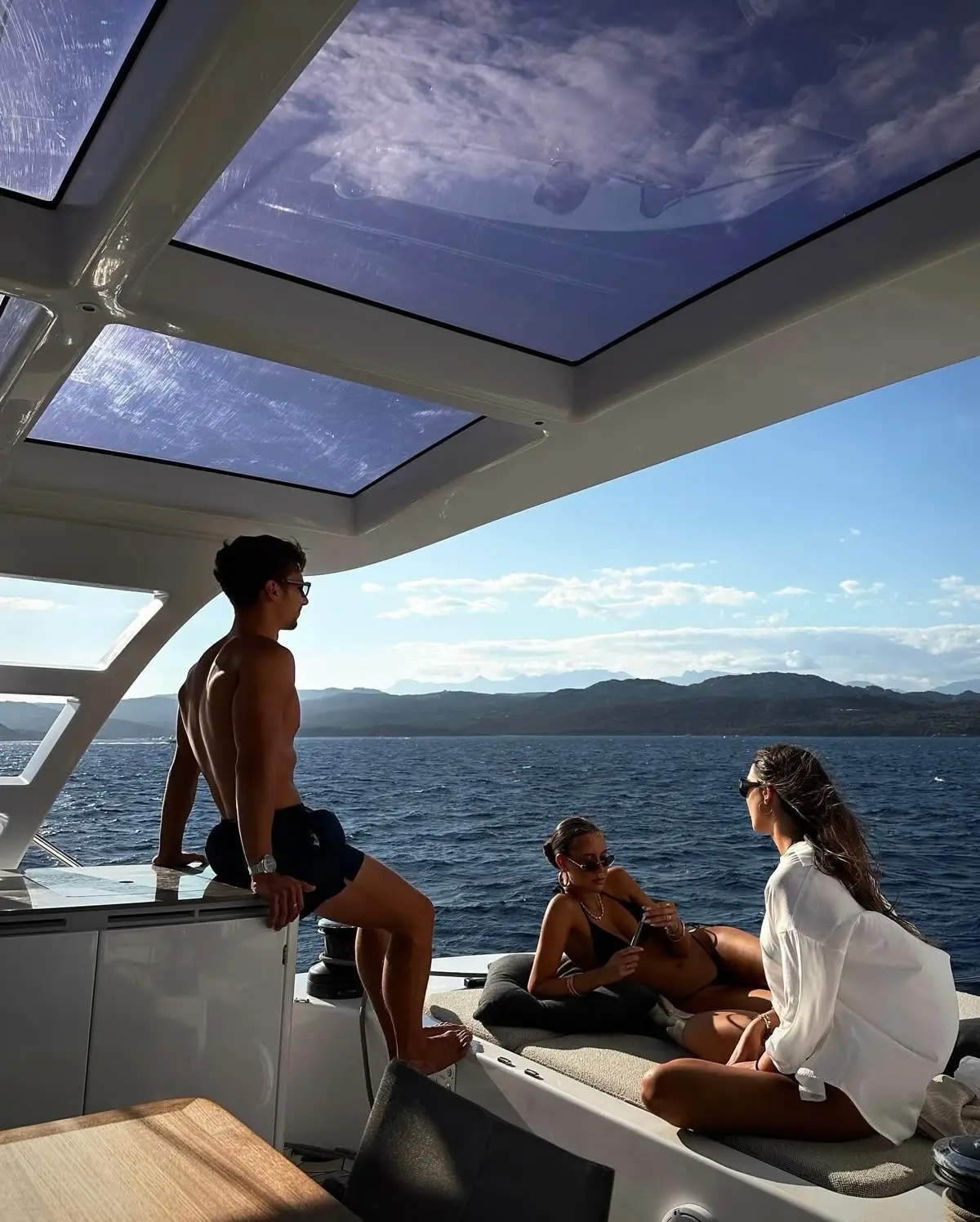 Friends relaxing on a yacht deck during a Mediterranean cruise