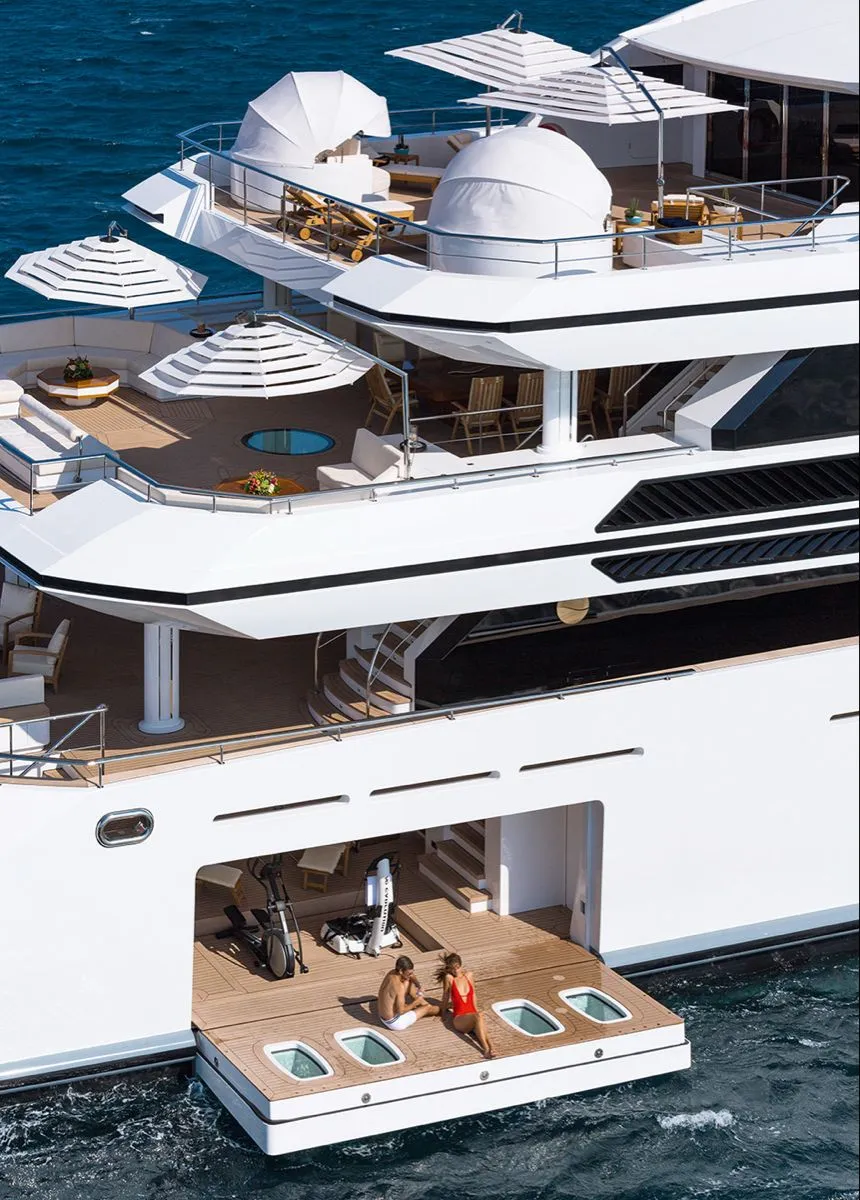 Guests relaxing on a superyacht swim platform at sea