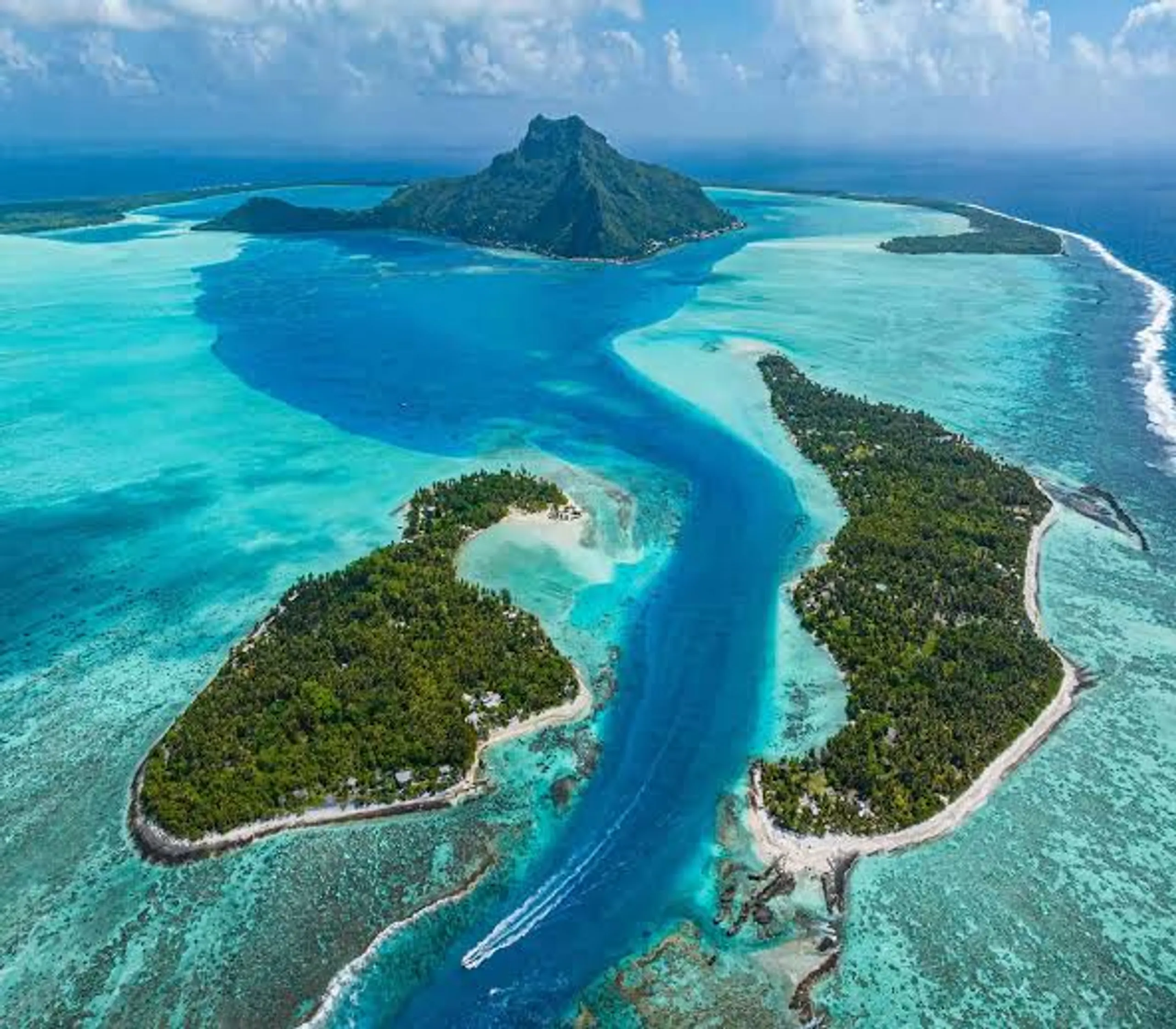 Aerial view of a tropical Pacific island lagoon with turquoise water and reef islands