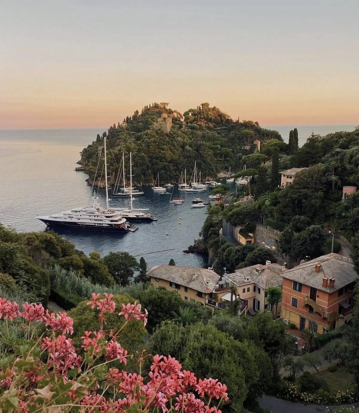 Luxury yachts anchored off the Italian Riviera coastline