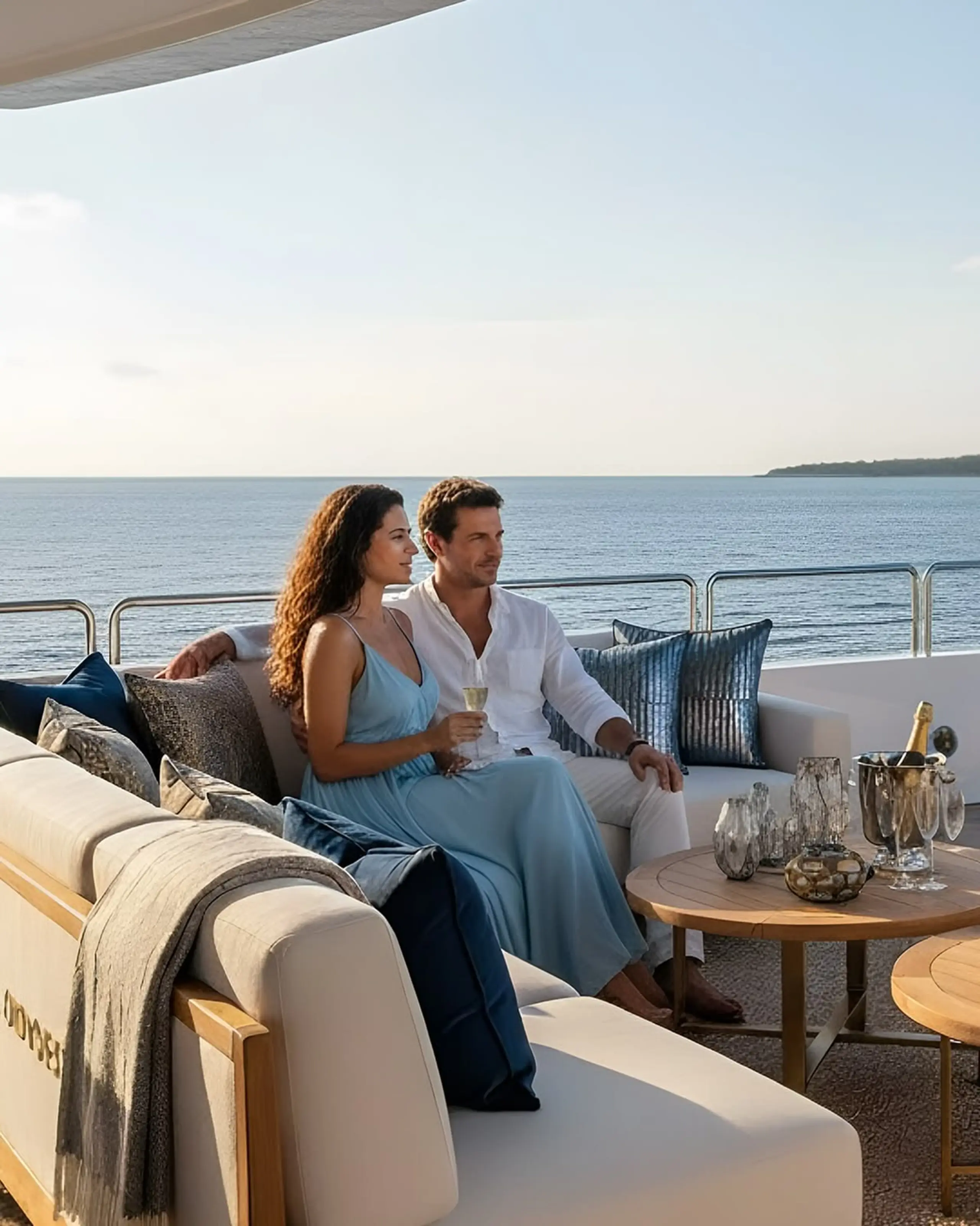 Couple relaxing on a private yacht deck at sea