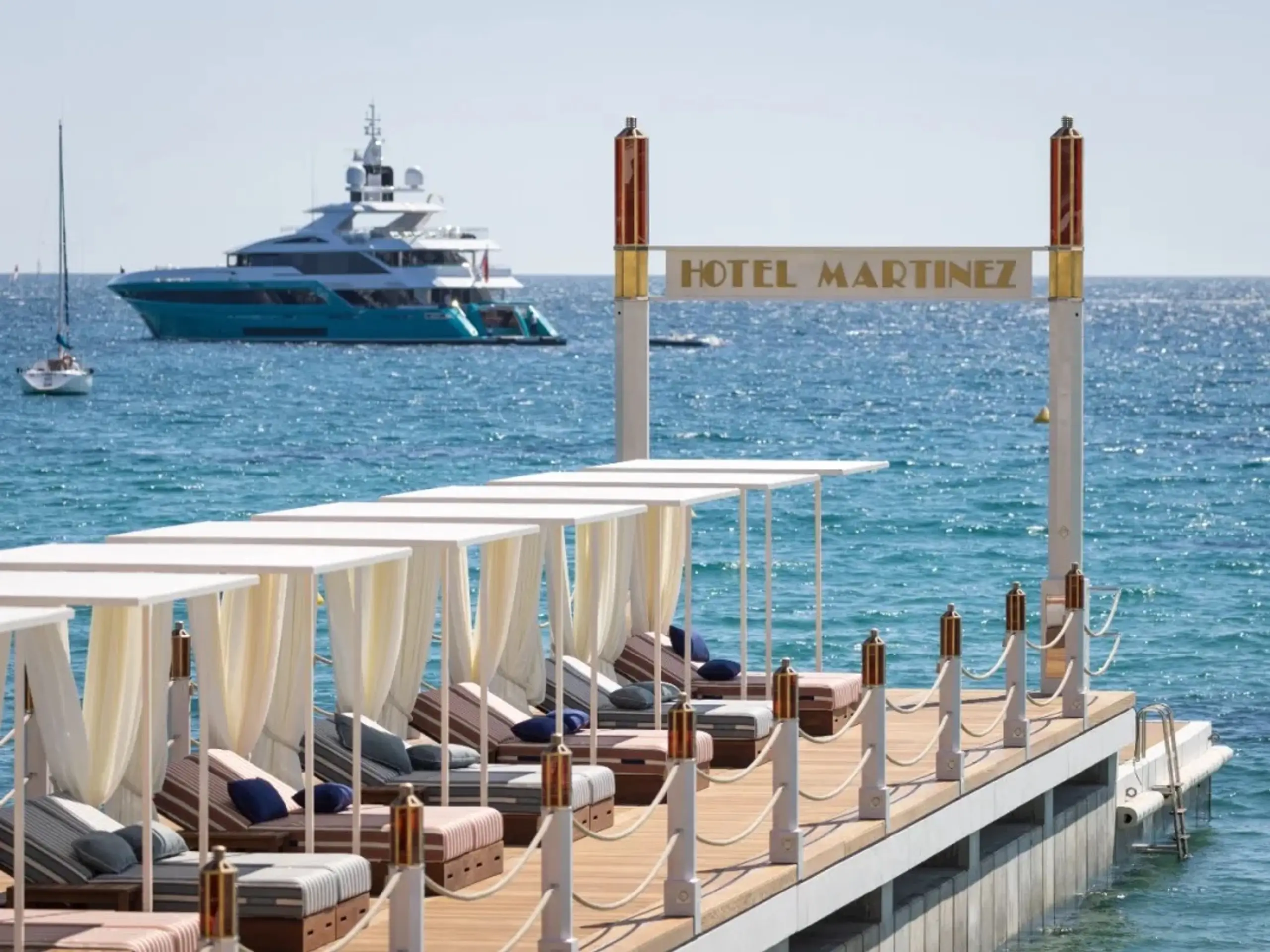 Hotel Martinez pier with a superyacht anchored off Cannes
