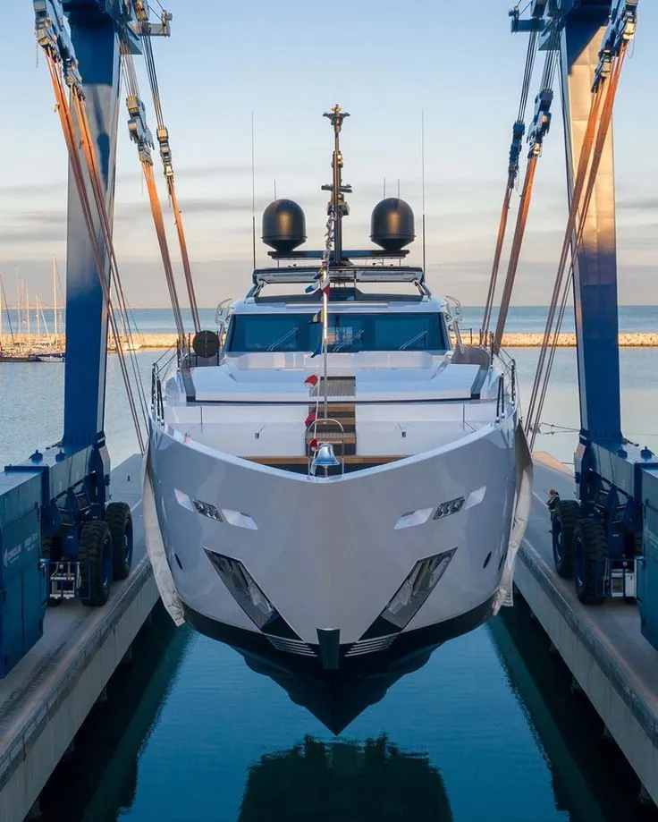 Luxury yacht being lifted at a shipyard before delivery or purchase inspection