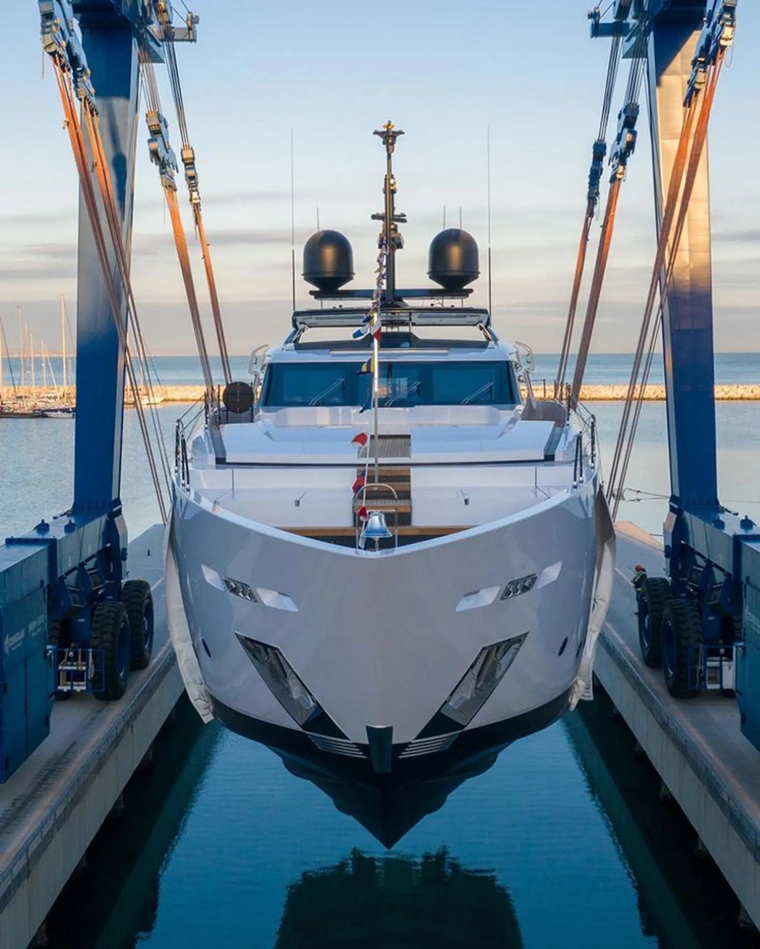 Luxury yacht being lifted at a shipyard before delivery or purchase inspection