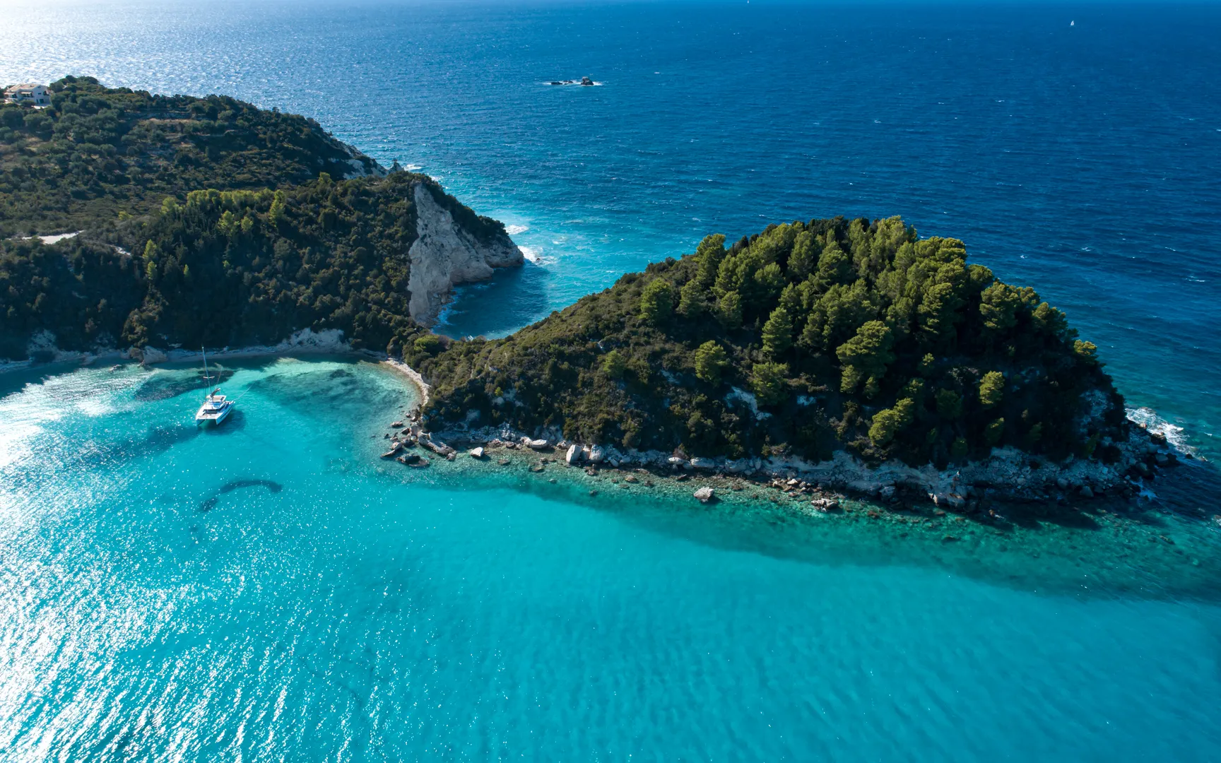 Luxury yacht anchored in a turquoise bay off Corfu in the Ionian Islands
