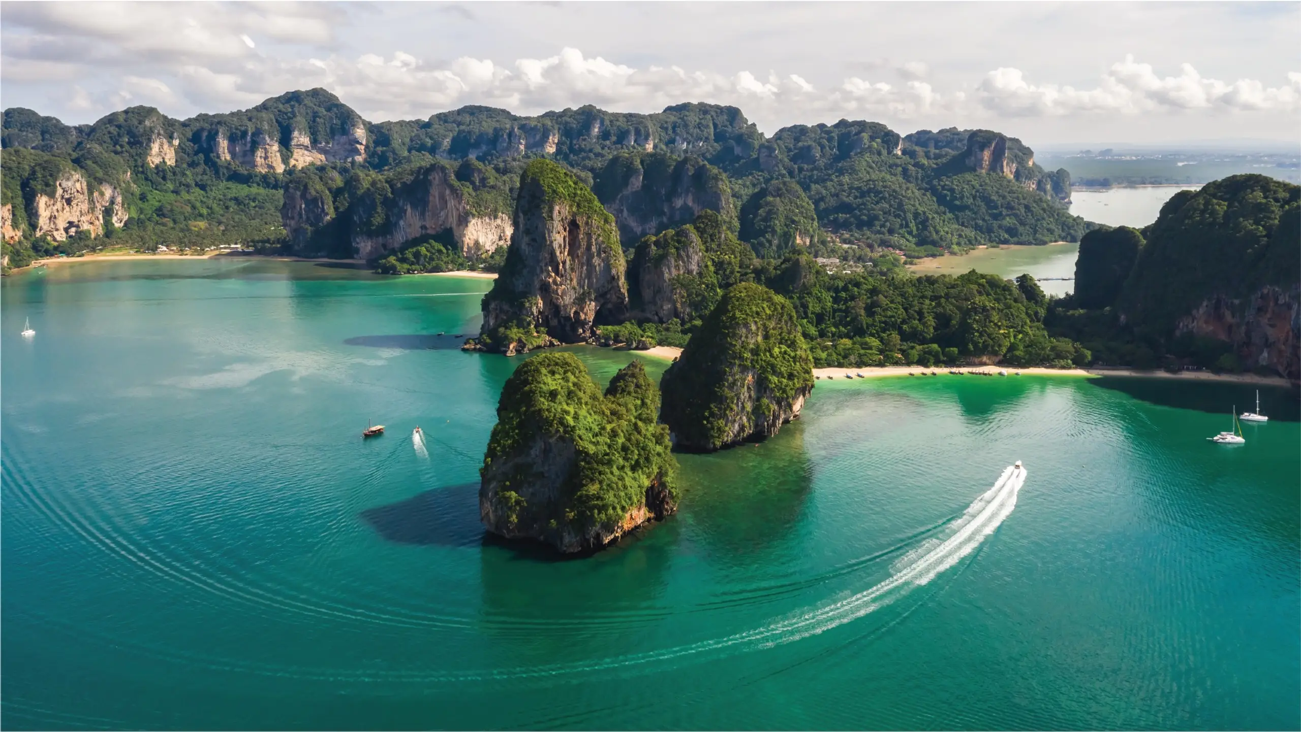 Yachts cruising among limestone cliffs in Phuket