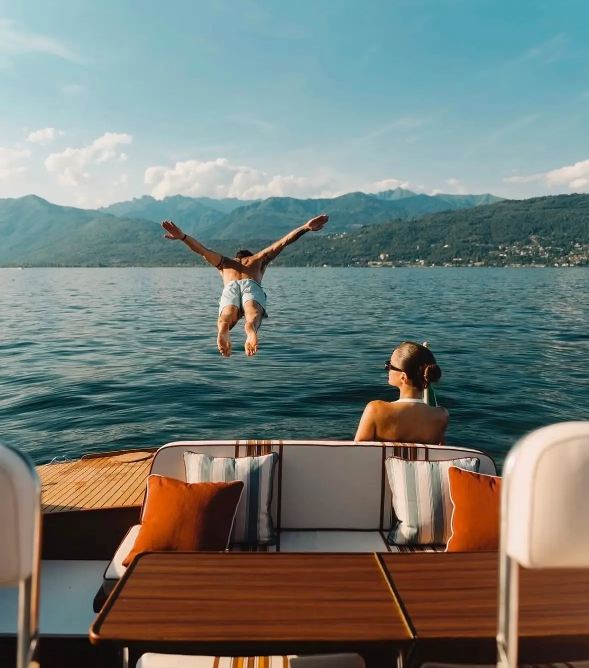 Man diving from a yacht into calm Mediterranean water
