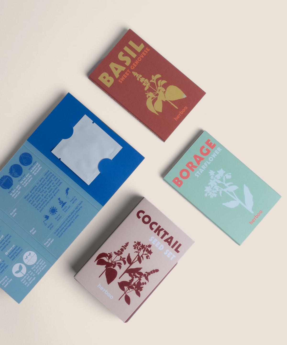 Flat lay of the Cocktail Seed Set with all seed packets arranged neatly alongside fresh herb sprigs and mixology tools.