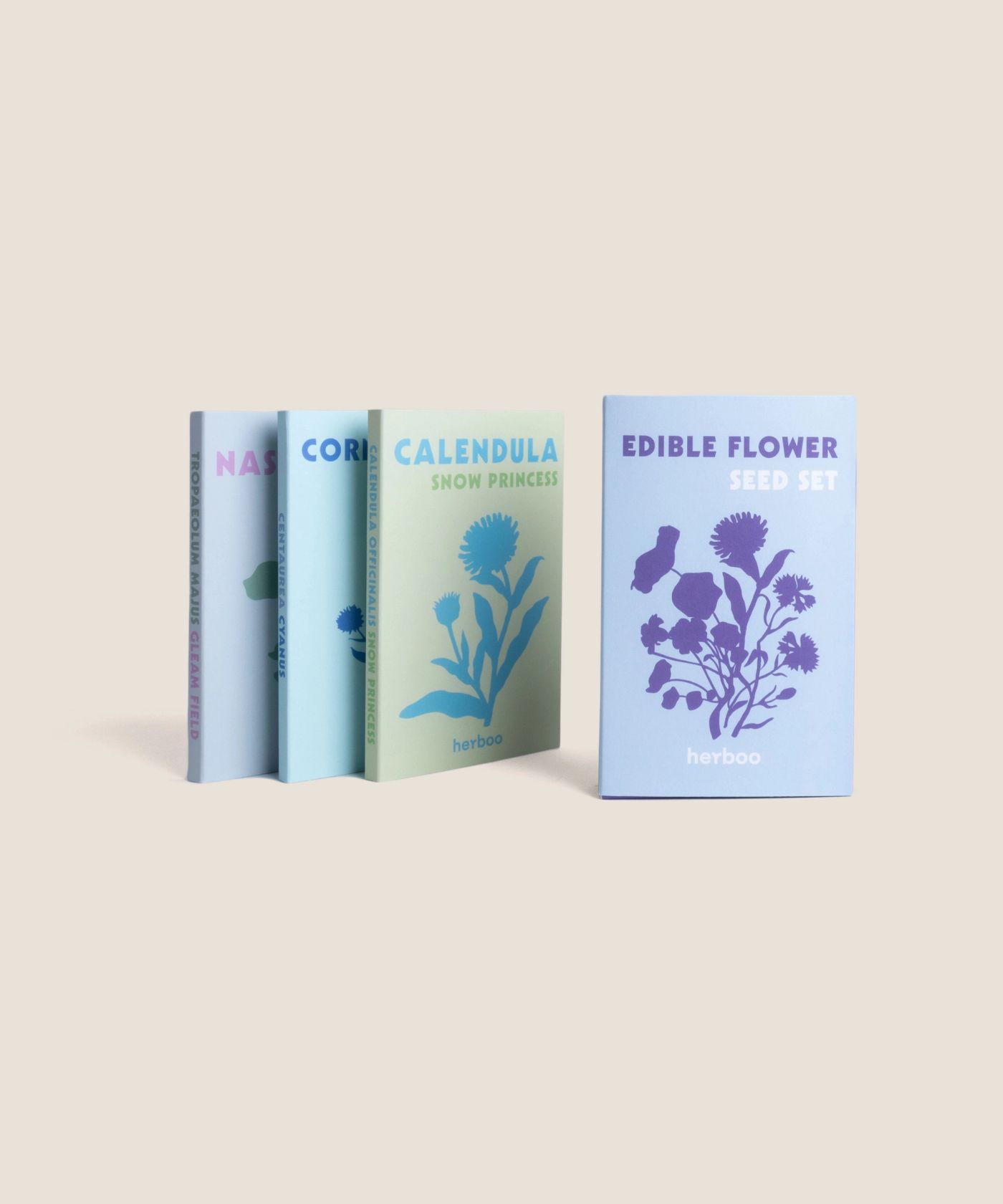 Herboo Edible Flower Seed Set with Nasturtium Gleam Fields, Cornflower Blue and Calendula Snow Princess seed packets.