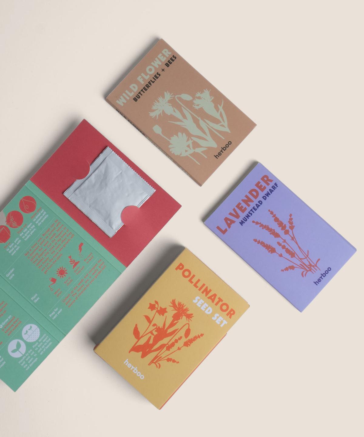 Flat lay of the Herboo Pollinator Seed Set showing all seed packets arranged overhead, including lavender, wildflower meadow mix, and borage.