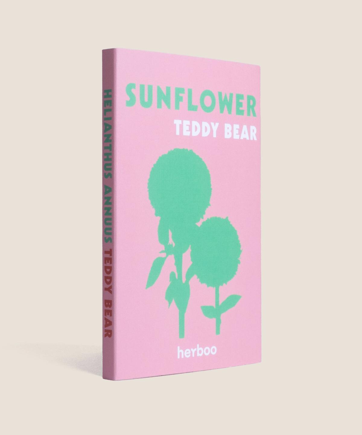 Side view of Herboo Teddy Bear Sunflower Seeds packet next to fluffy dwarf sunflower bloom.