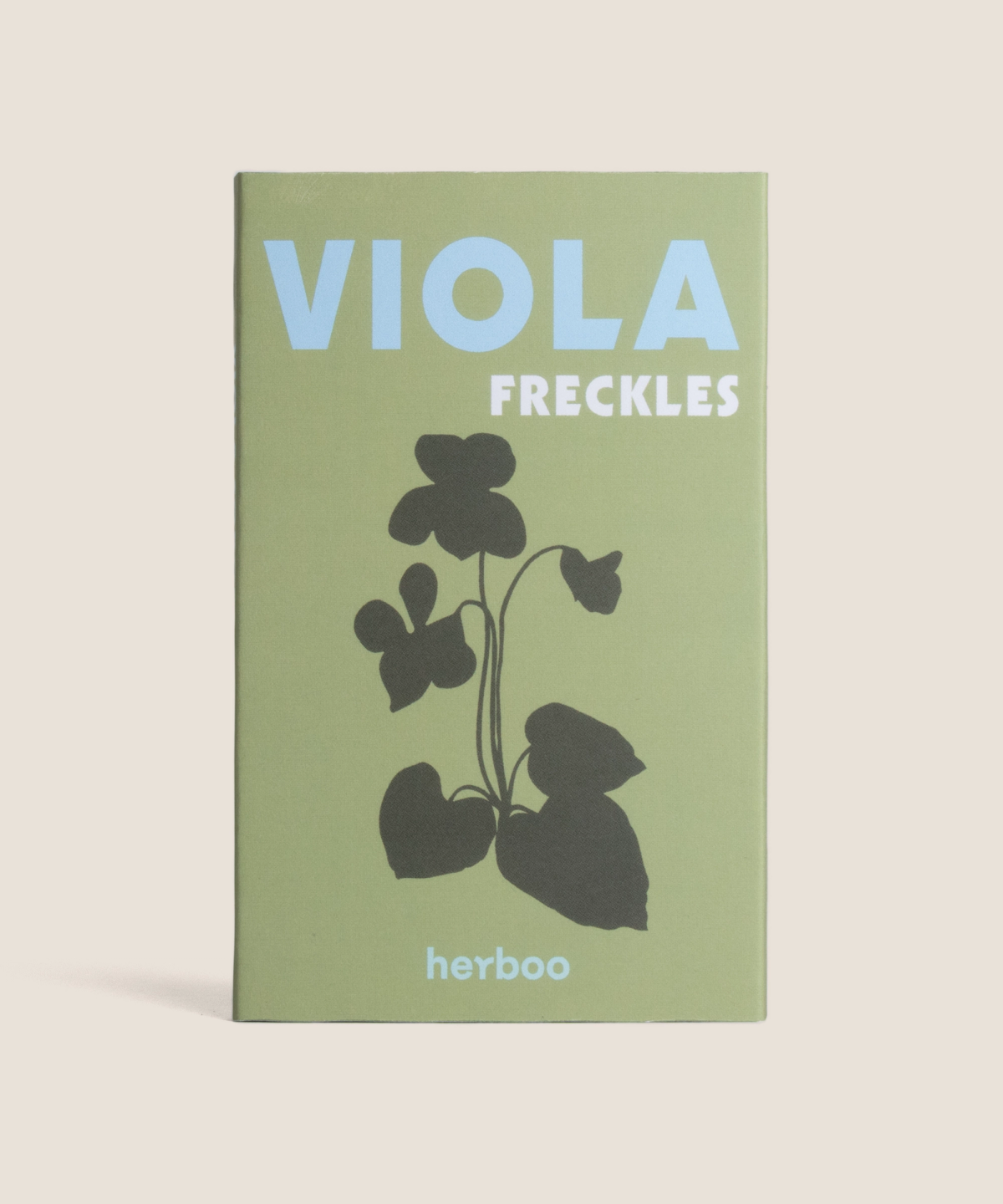 Herboo Viola ‘Freckles’ seed packet with white and blue-speckled flower illustration on a plain background