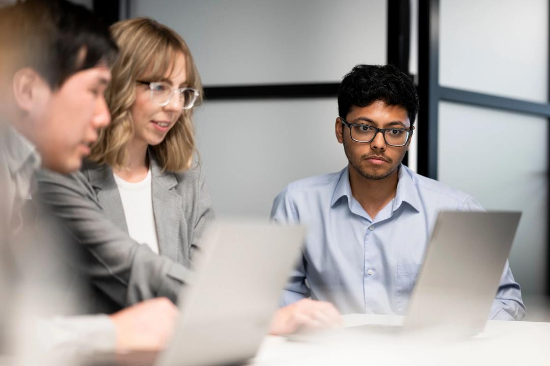 Digital marketing expert having training session with female in meeting room.