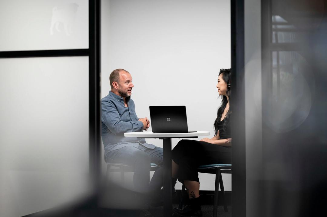 Male CEO in cloud consulting session with female client.