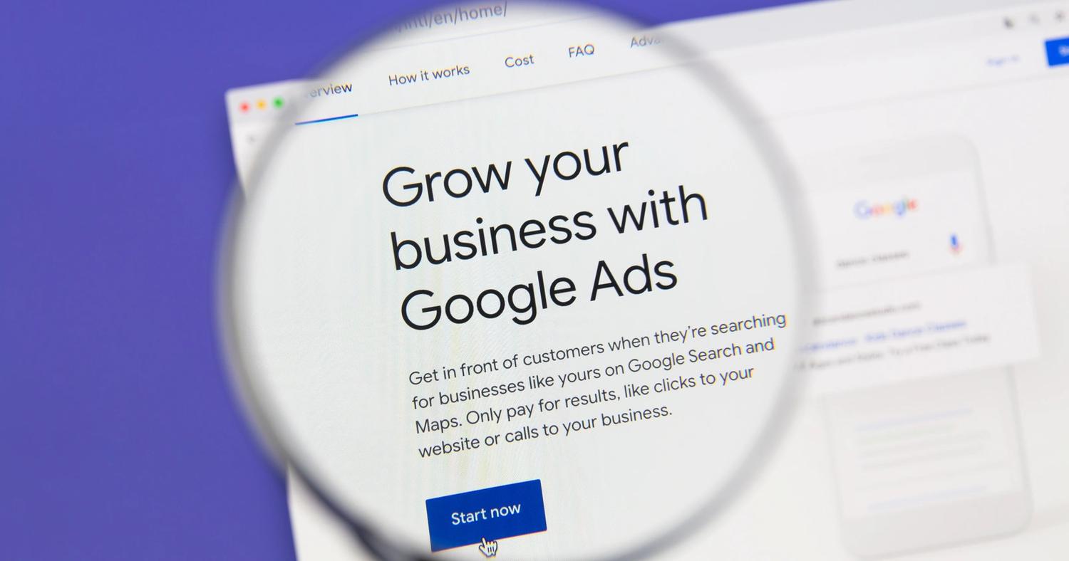Magnifying glass over webpage text - Grow your business with Google Ads