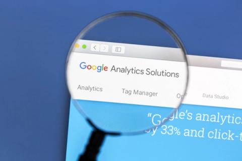 Magnifying glass over Google Analytics and Tag Manager