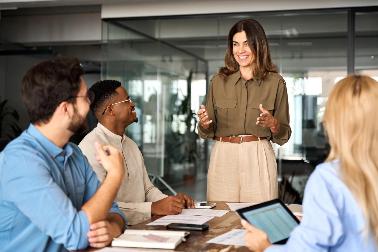 Happy business woman discussing enterprise SEO services at office corporate board group meeting.