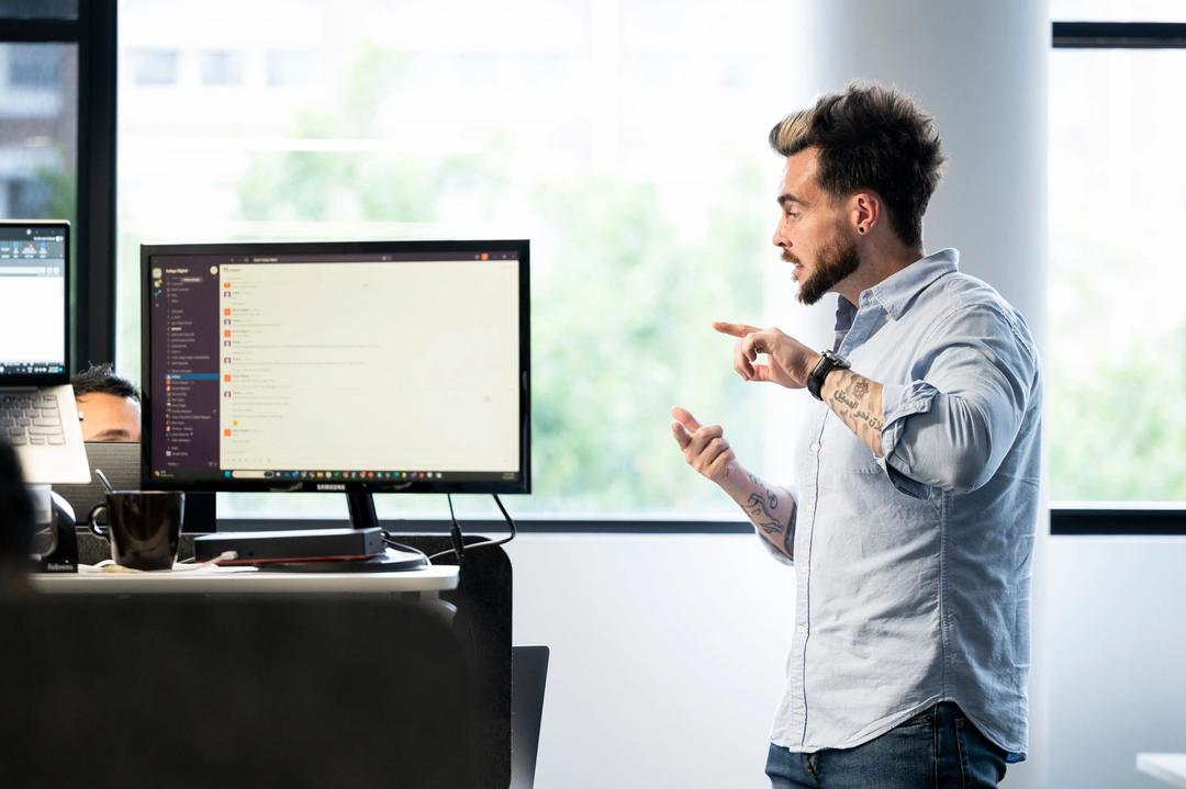 Digital marketing expert standing during training session with team.