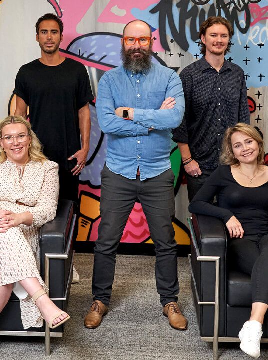 Five digital marketing specialists pose for photo.