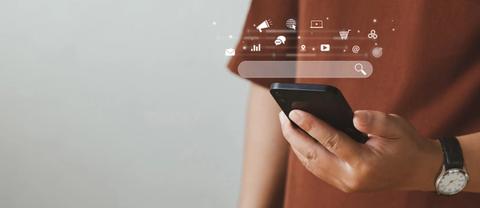 Man with watch using smartphone with SEO icons and google search bar to generate organic traffic.