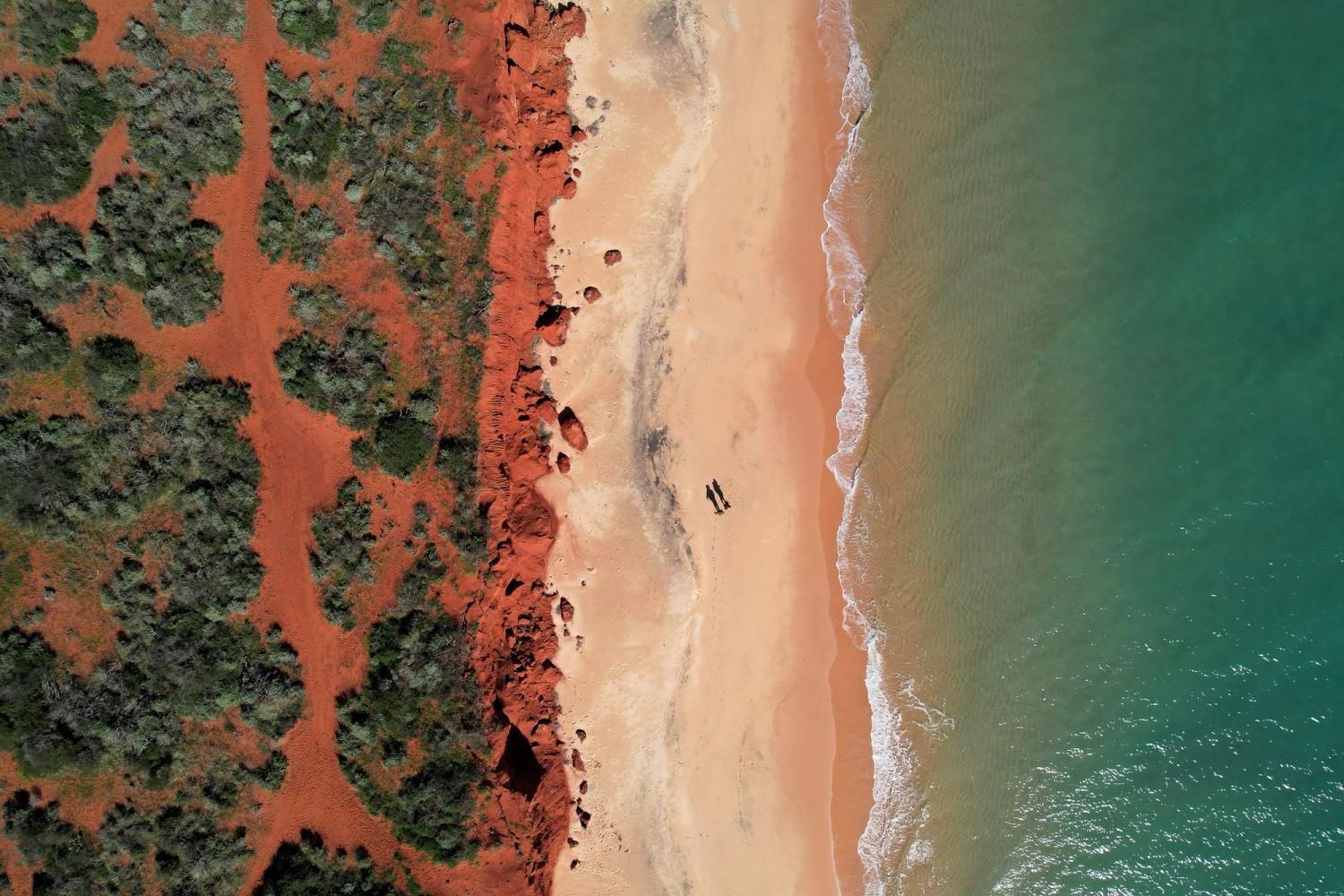 erial picture of red sand, beach and the ocean in Shark Bay, Western Australia.