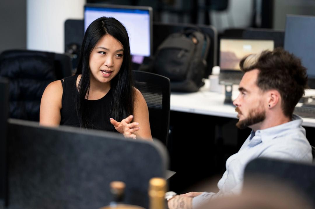Female SEO consultant discussing findings with male collegue.