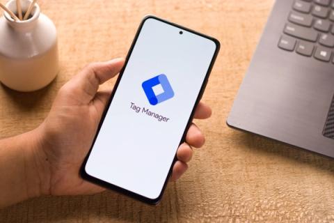 Phone in hand with Google Tag Manager logo