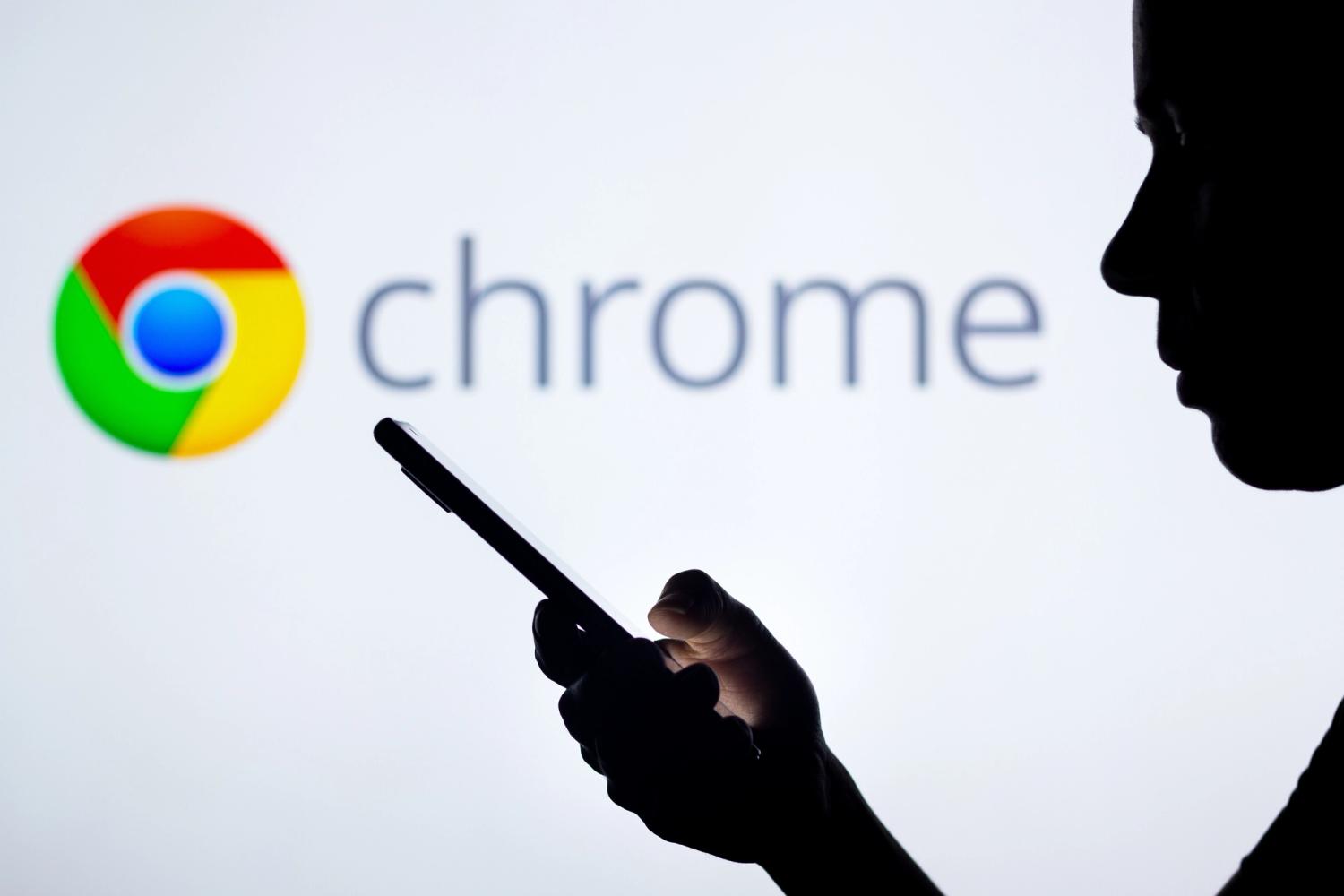 Google Chrome logo in the background of a silhouetted woman holding a mobile phone.