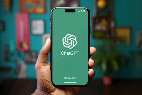 Hand holding phone with Chatgpt logo