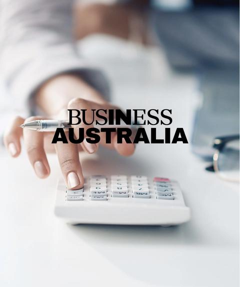 Employe using calculator at table with Business Australia logo overlay.