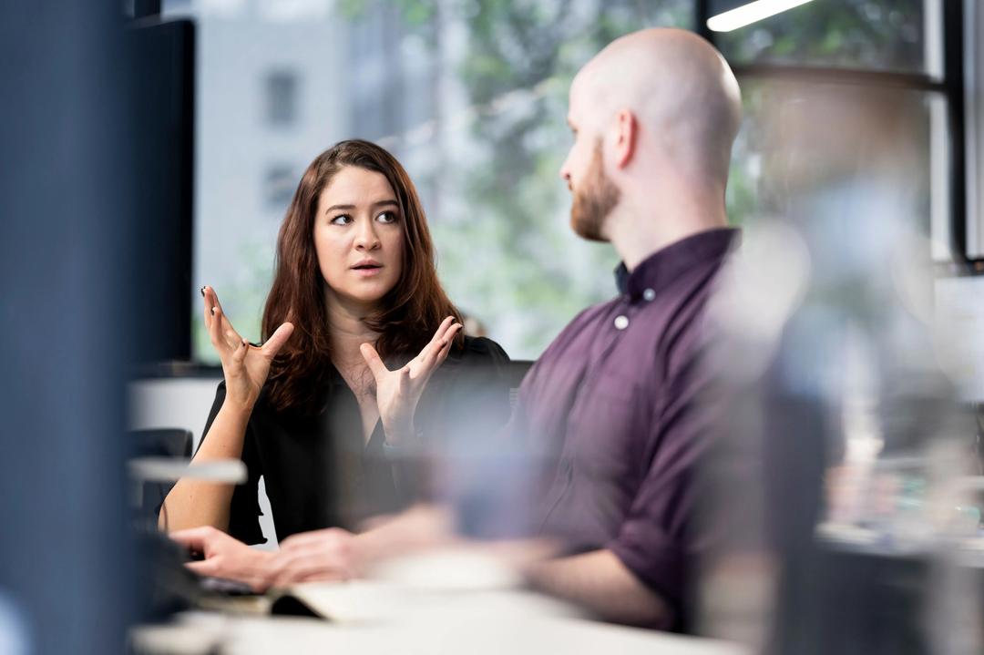 Male and female tiktok ad experts working on a campaign.