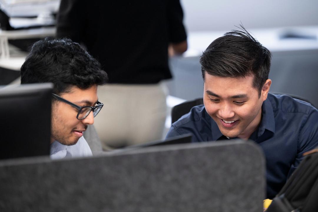 Two male digital marketing experts doing training in an office.