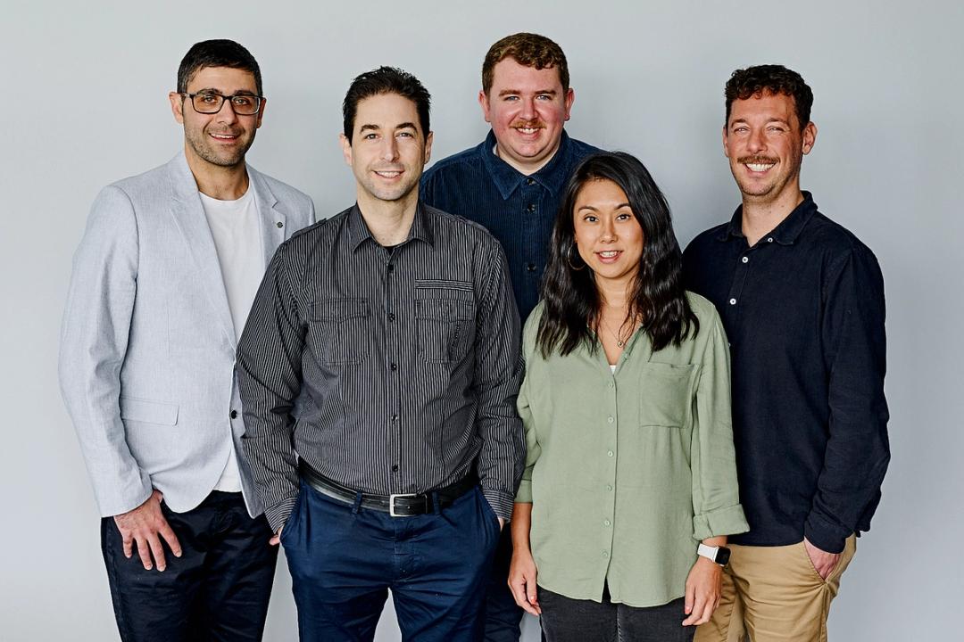 Four digital marketing consultants from Alley Melbourne standing in front of a grey wall.