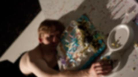 a dead body with short hair and a dress, face down in a birthday cake