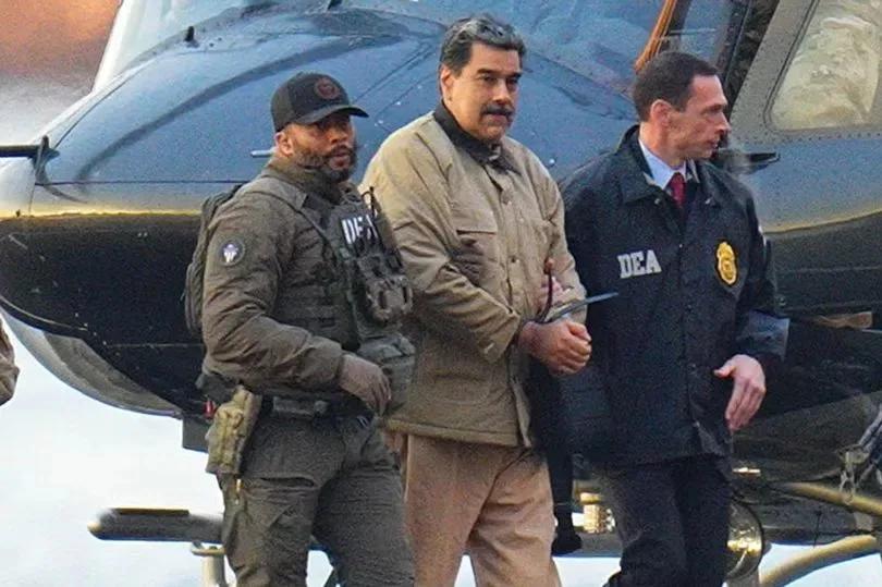 Imagen suministrada de Nicolás Maduro entre dos hombres con insignias de la DEA, junto a una aeronave.