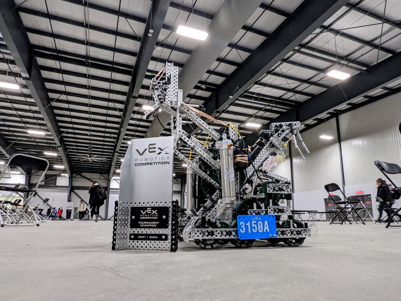 Team 3150A robot beside an award at a robotics event