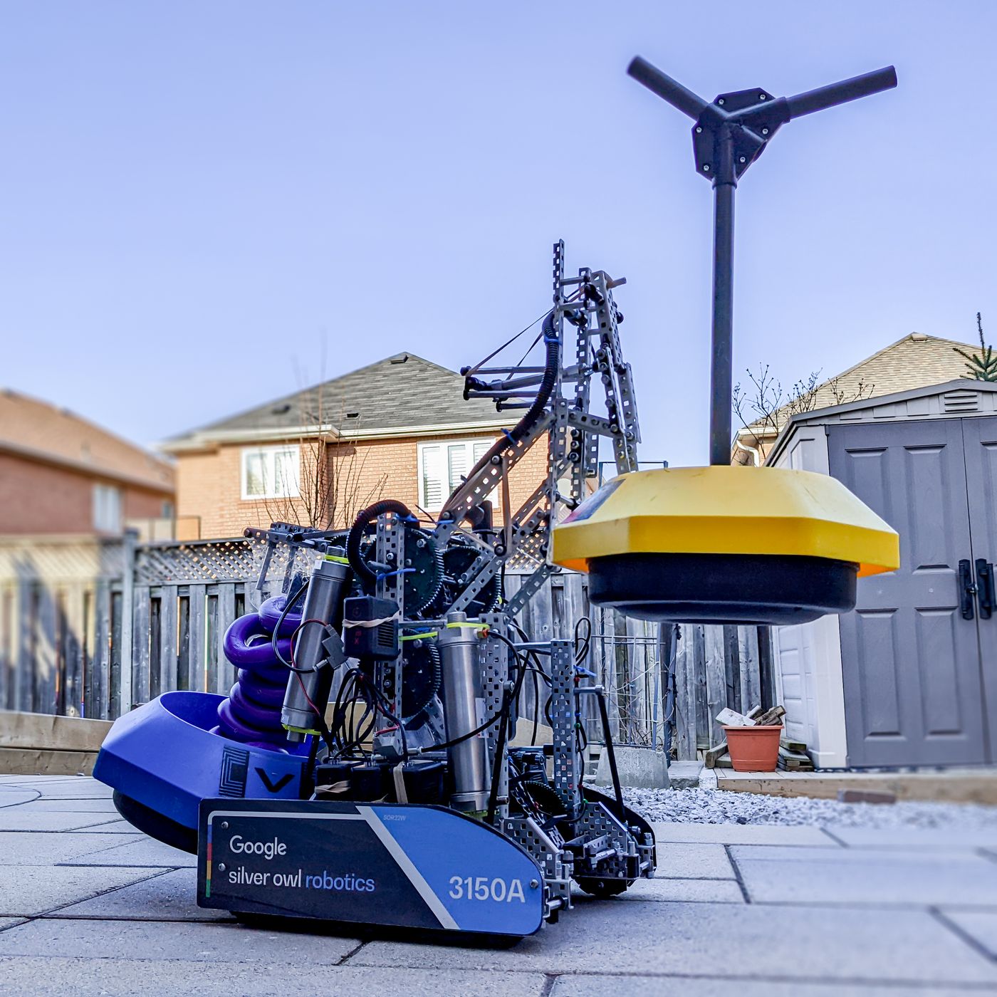 Team 3150A robot with a yellow game goal outdoors