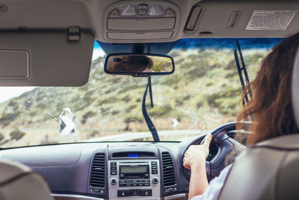 Women driving with car wipers on