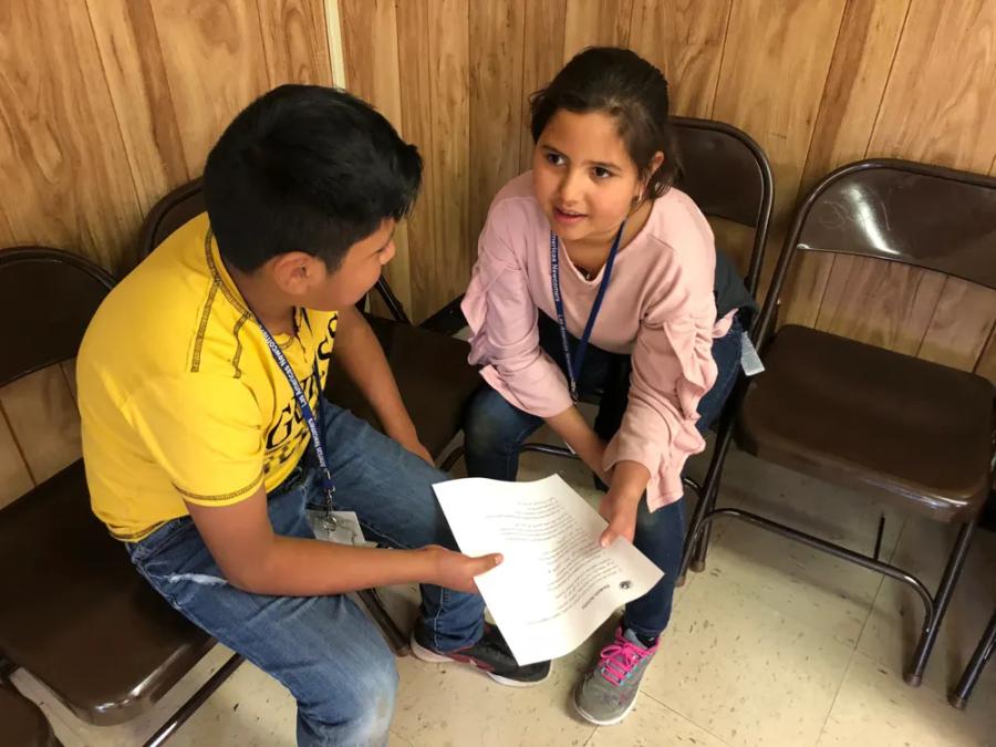 Two students talking through a worksheet together