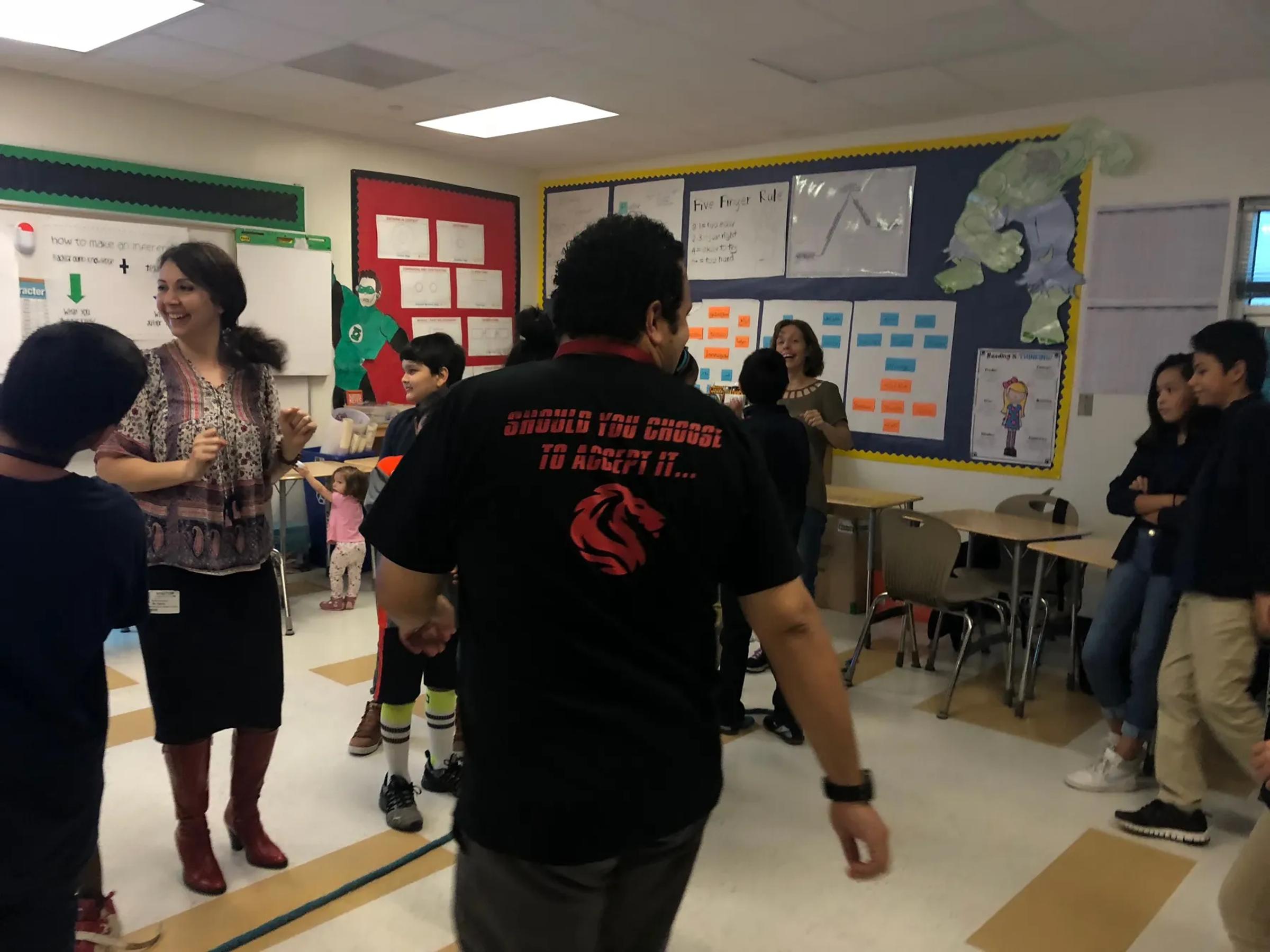 An educator leading a group of students in a classroom