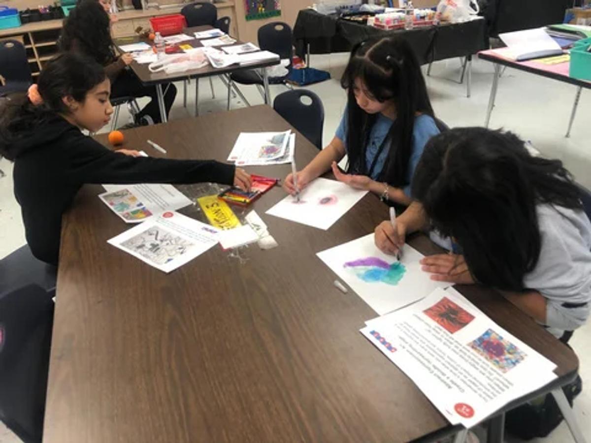 Students working with colors and emotion tools at their tables