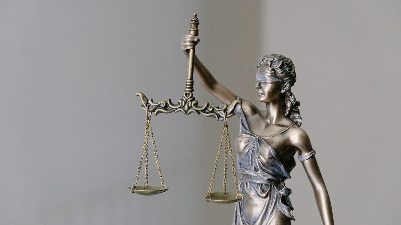 Estátua da Justiça, de olhos vendados, segurando a balança
