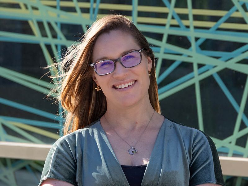Laurie Stirling smiling with arms folded