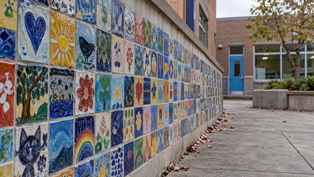 Colorful student-made tiles on school wall